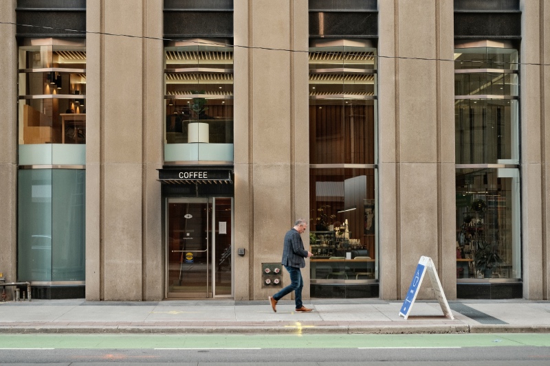 Man walking down Queen Street in Toronto