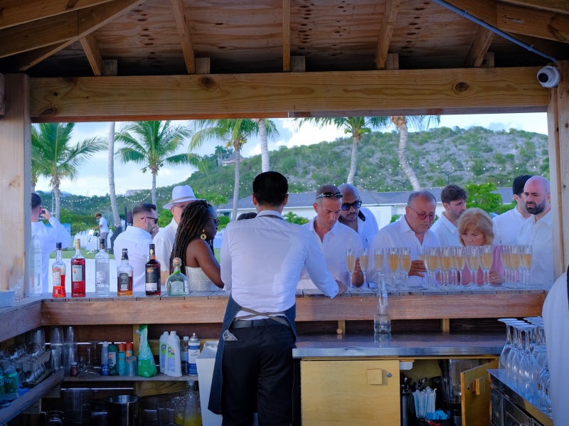 Bartender serving people drinks at the beach bar in Turks and Caicos.