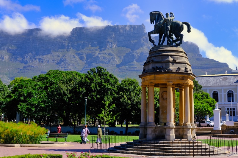 Statue of a man and horse in Cape Town's Rose Garden, with Table Mountain in the background.