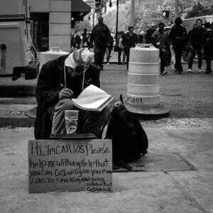 Carlos writing poetry on the streets of Manhattan, New York City. 2016 © Amha Mogus